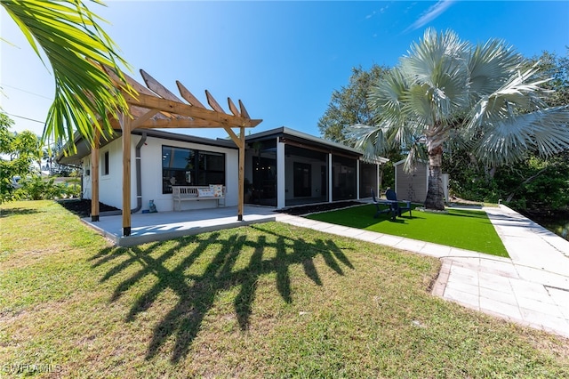 rear view of property with a patio, a lawn, a sunroom, a pergola, and an outdoor structure