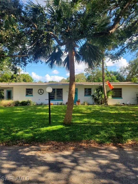 ranch-style home featuring a front yard