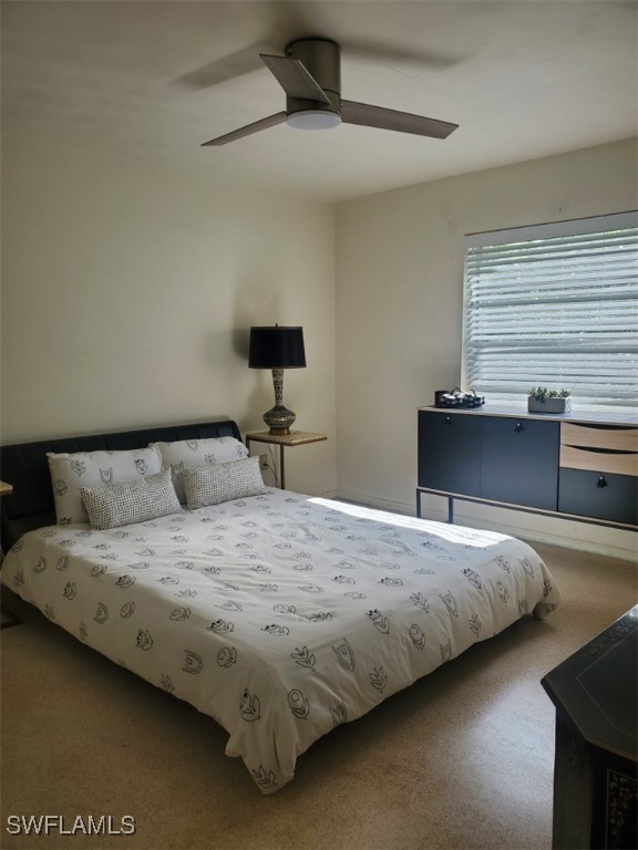 bedroom with ceiling fan and carpet floors