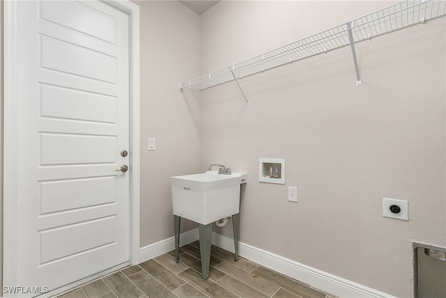 laundry area featuring laundry area, baseboards, hookup for a washing machine, wood tiled floor, and hookup for an electric dryer