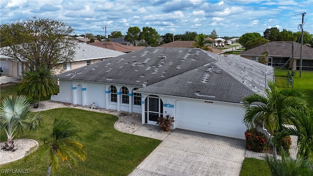 view of front facade with a front yard and a garage