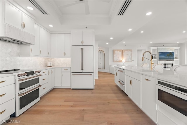 kitchen with sink, light hardwood / wood-style flooring, white cabinets, and appliances with stainless steel finishes