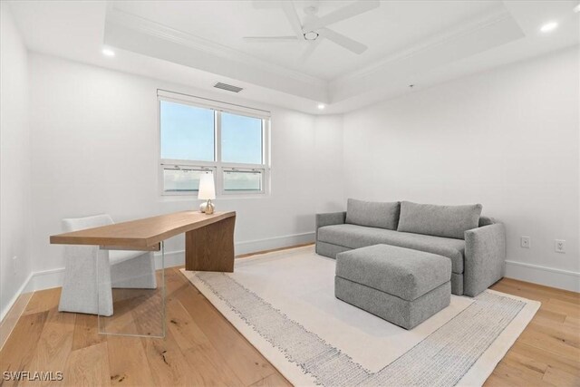 4951 Bonita Bay Blvd Unit 2205, Bonita Springs, FL 34134 - sitting room with a tray ceiling, crown molding, wood finished floors, a ceiling fan, and baseboards