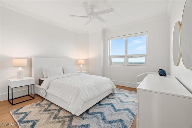 4951 Bonita Bay Blvd Unit 2205, Bonita Springs, FL 34134 - bedroom with ornamental molding, light wood-style floors, baseboards, and ceiling fan