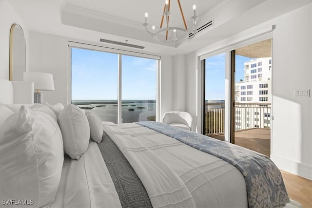 4951 Bonita Bay Blvd Unit 2205, Bonita Springs, FL 34134 - bedroom featuring crown molding, a tray ceiling, a chandelier, access to exterior, and light wood-style flooring