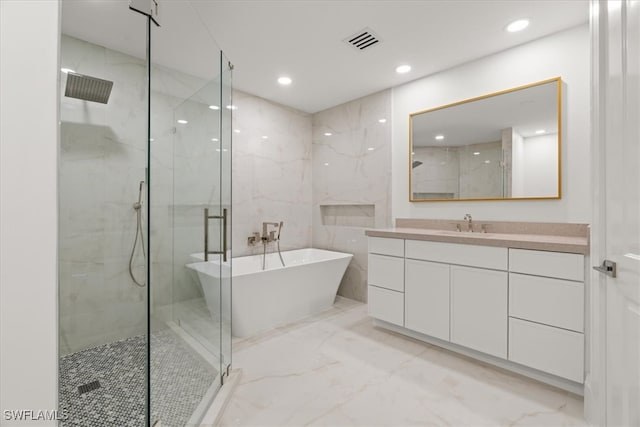 bathroom featuring vanity and shower with separate bathtub