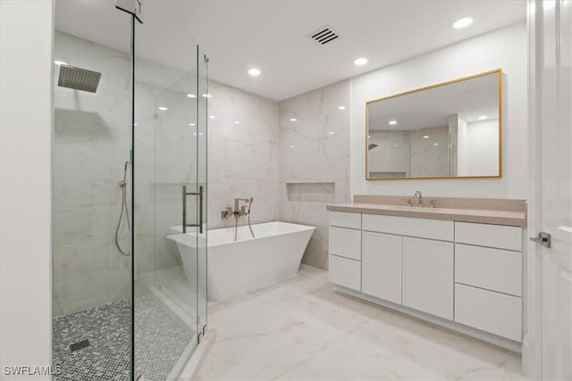 4951 Bonita Bay Blvd Unit 2205, Bonita Springs, FL 34134 - full bathroom featuring marble tiled floors, a shower stall, a freestanding tub, vanity, and recessed lighting