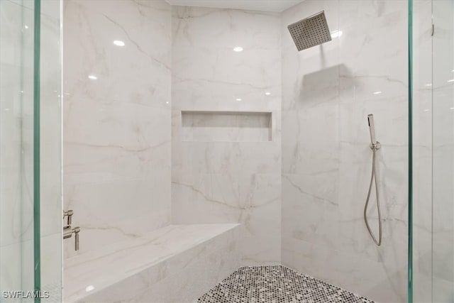 bathroom with a tile shower