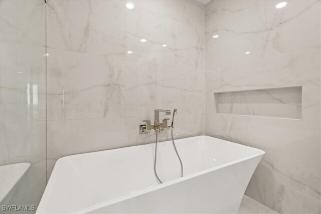 4951 Bonita Bay Blvd Unit 2205, Bonita Springs, FL 34134 - full bath featuring tile walls and a freestanding bath