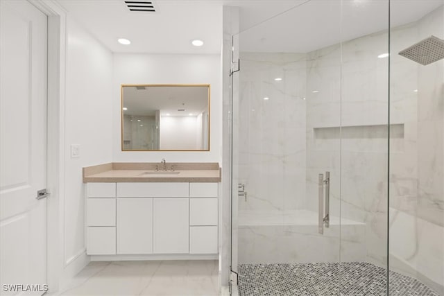 bathroom featuring vanity and a shower with shower door