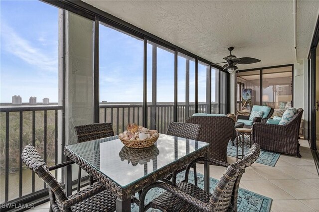 sunroom featuring ceiling fan