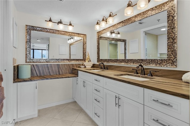 bathroom featuring tile patterned floors, double vanity, backsplash, and a sink