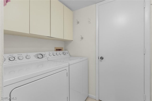 laundry area featuring washing machine and clothes dryer and cabinet space