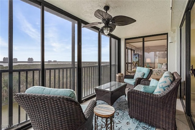 sunroom / solarium with a ceiling fan