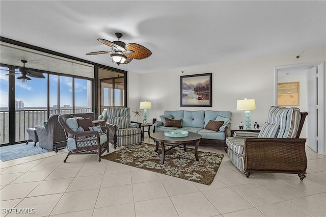 living area featuring light tile patterned floors, a ceiling fan, and expansive windows