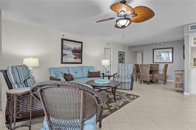 living room featuring light tile patterned flooring, visible vents, baseboards, and ceiling fan