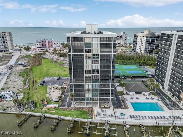 view of building exterior with a water view and a view of city