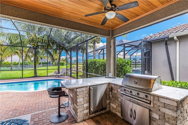 view of patio / terrace featuring area for grilling, an outdoor bar, grilling area, and glass enclosure