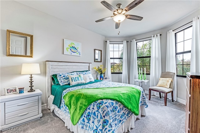 bedroom with carpet floors, multiple windows, and ceiling fan