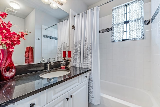 bathroom featuring shower / bath combo and vanity