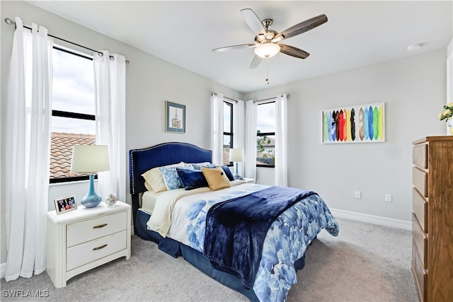 bedroom featuring light carpet and ceiling fan