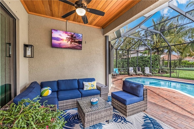 view of patio with a lanai, ceiling fan, and an outdoor living space