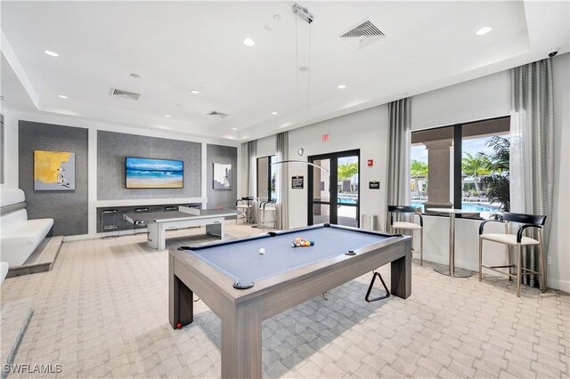 rec room with light carpet, french doors, a raised ceiling, and billiards