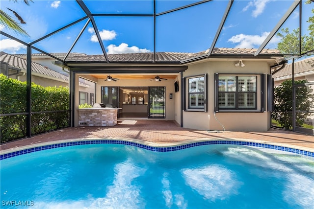 view of pool featuring a patio, ceiling fan, and a lanai