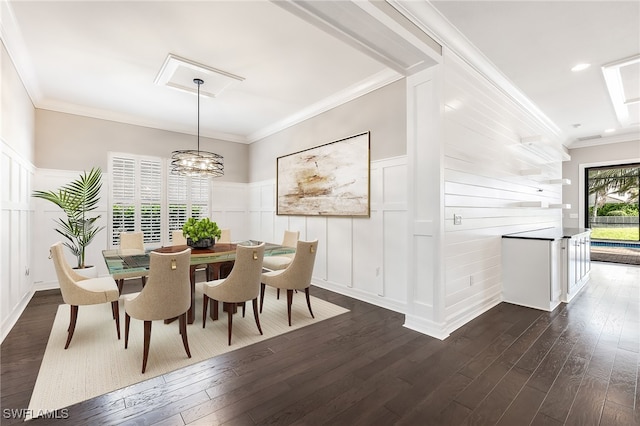 dining room with a chandelier, dark hardwood / wood-style flooring, and ornamental molding