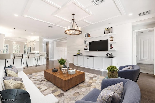 living room featuring wooden walls, light hardwood / wood-style floors, and a notable chandelier