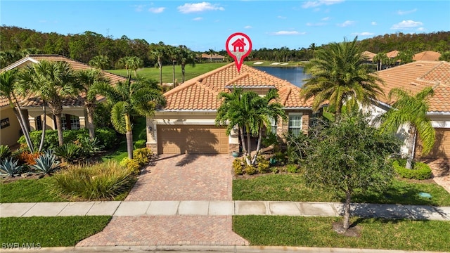 mediterranean / spanish house with a water view and a garage