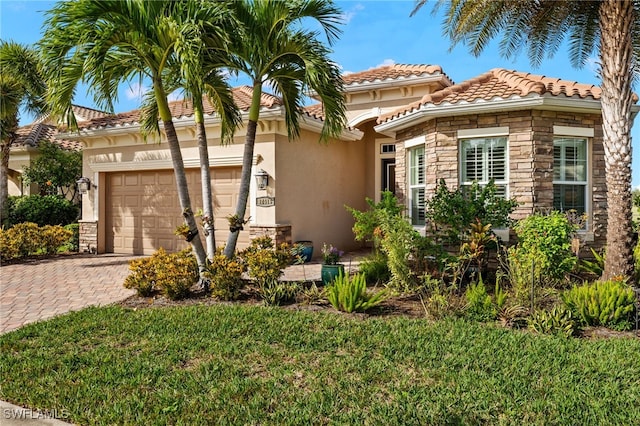 mediterranean / spanish house with a garage