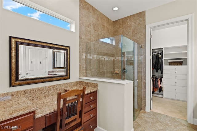 bathroom with tile patterned flooring and walk in shower