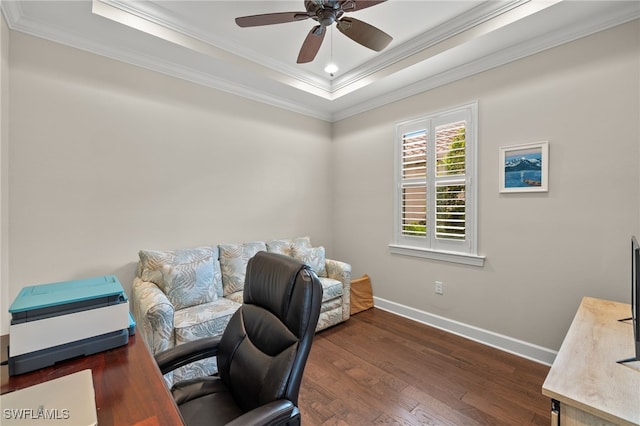 office area featuring dark hardwood / wood-style floors, ceiling fan, crown molding, and a tray ceiling