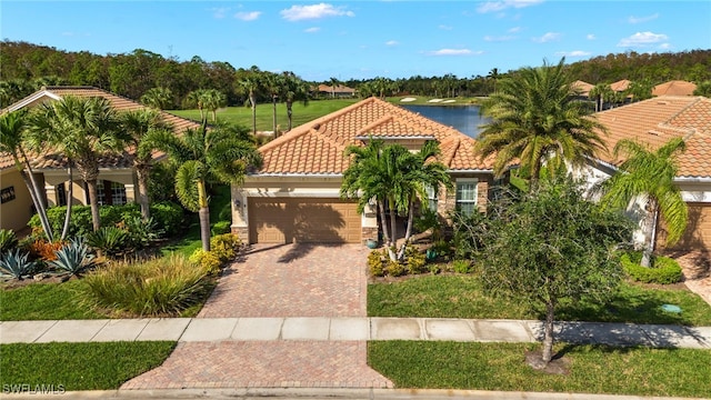 mediterranean / spanish house featuring a water view and a garage