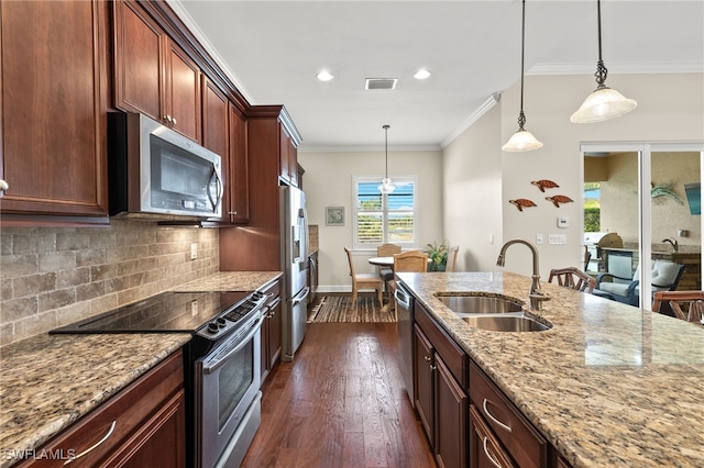 kitchen with pendant lighting, sink, light stone counters, dark hardwood / wood-style flooring, and stainless steel appliances