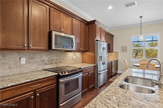 kitchen with crown molding, sink, light stone counters, dark hardwood / wood-style flooring, and stainless steel appliances