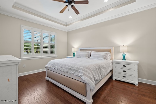 bedroom with a raised ceiling, ceiling fan, dark hardwood / wood-style flooring, and crown molding