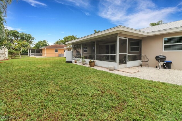 2600 Poinciana St, Naples, FL 34105 - view of grassy yard featuring a sunroom