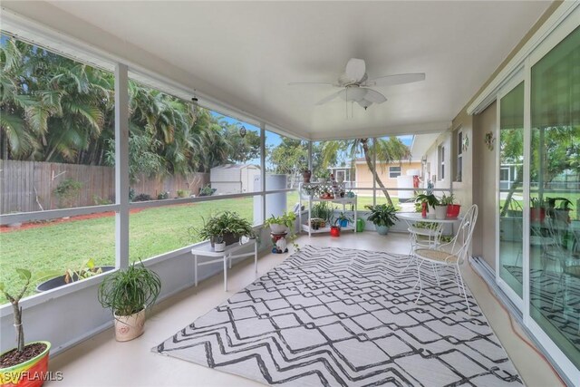 unfurnished sunroom featuring ceiling fan