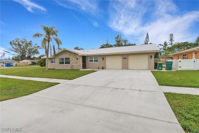 single story home featuring a garage and a front yard