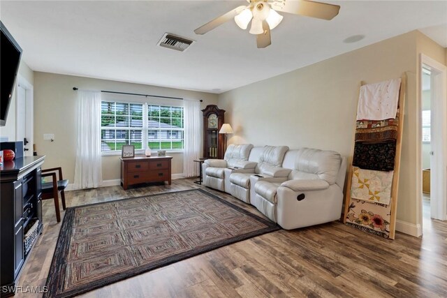 living room with ceiling fan and hardwood / wood-style floors