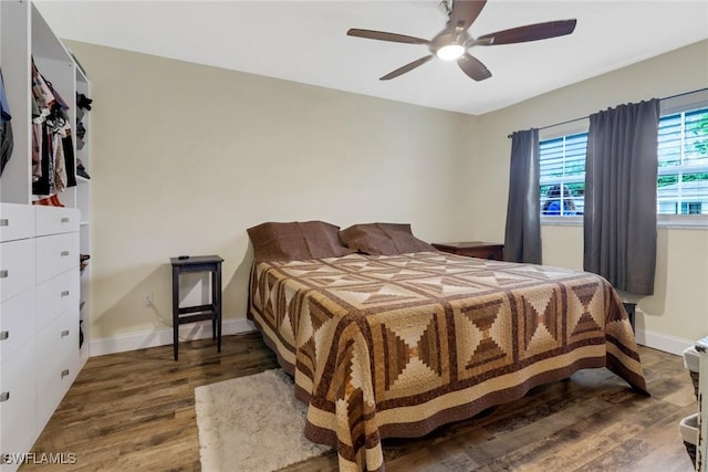 bedroom with ceiling fan and dark hardwood / wood-style flooring