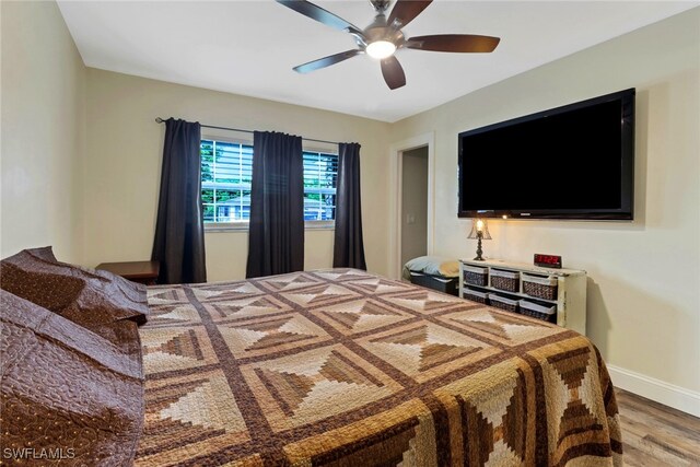 bedroom with ceiling fan and hardwood / wood-style flooring