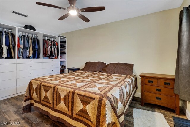 bedroom with ceiling fan, a closet, and dark wood-type flooring