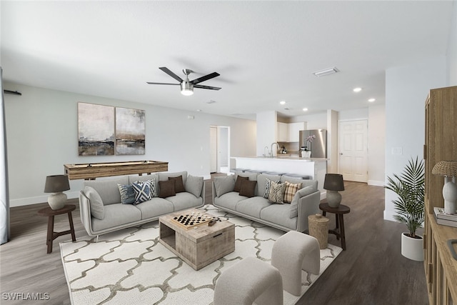 living room with ceiling fan and hardwood / wood-style floors