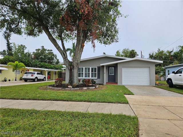 ranch-style house featuring a garage and a front yard