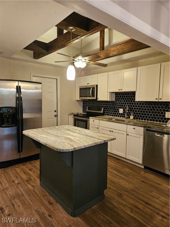 kitchen with tasteful backsplash, dark hardwood / wood-style flooring, white cabinets, and stainless steel appliances