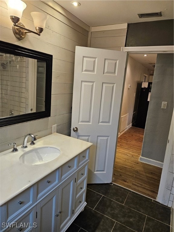 bathroom with hardwood / wood-style floors and vanity