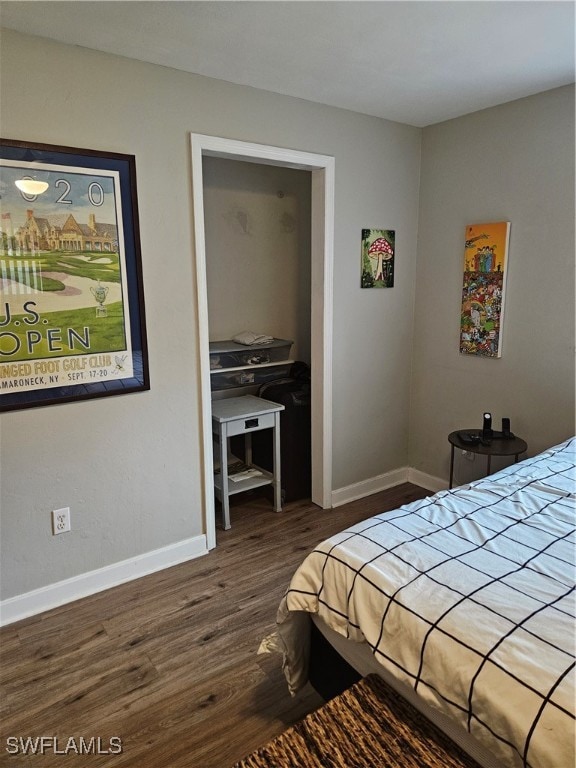 bedroom with dark wood-type flooring